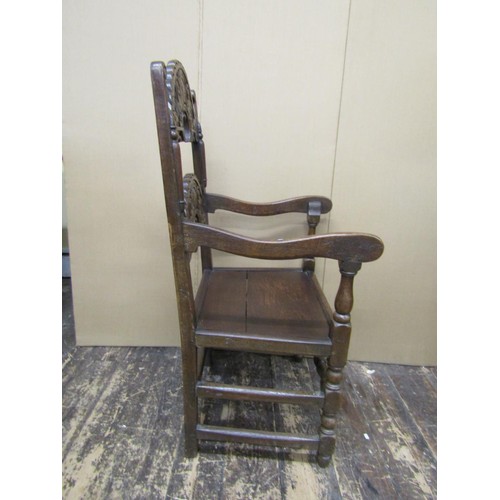 1374 - An antique oak South Yorkshire elbow chair of traditional form with carved and arched ladder back, s... 