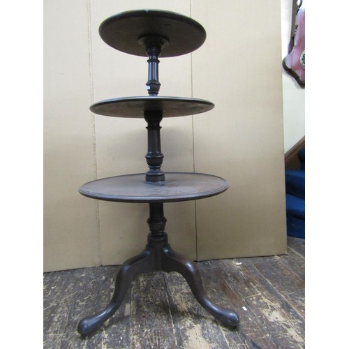 1392 - A George III mahogany three tier dumb waiter on turned column and tripod base, 112cm high