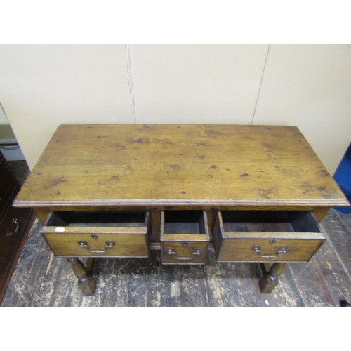 1395 - A good quality contemporary Georgian style side table incorporating three drawers on turned supports... 