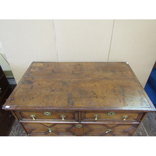 1412 - An early 18th century oak chest of three long and two short drawers with geometric block moulded det... 