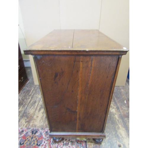 1412 - An early 18th century oak chest of three long and two short drawers with geometric block moulded det... 