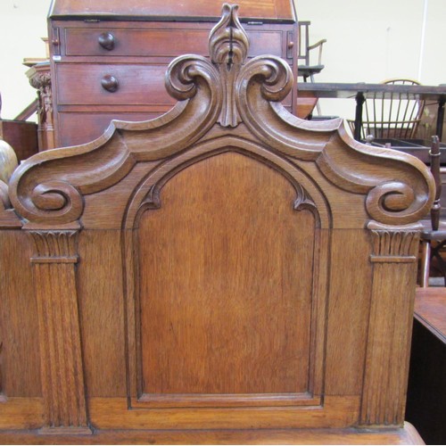 1378 - A Victorian oak sideboard with heavy Gothic influence, the base enclosed by two cupboards and three ... 