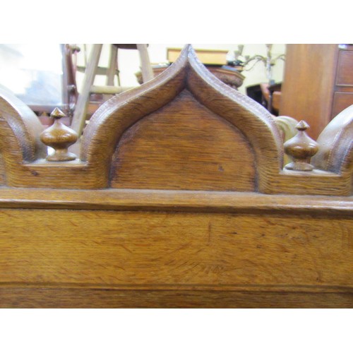 1378 - A Victorian oak sideboard with heavy Gothic influence, the base enclosed by two cupboards and three ... 