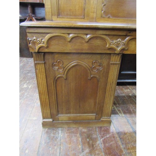 1378 - A Victorian oak sideboard with heavy Gothic influence, the base enclosed by two cupboards and three ... 