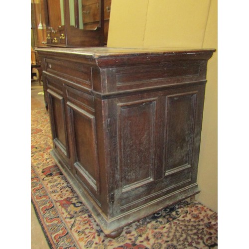 1388 - An 18th century oak enclosed chest of drawers, the front elevation presented as two doors with deep ... 