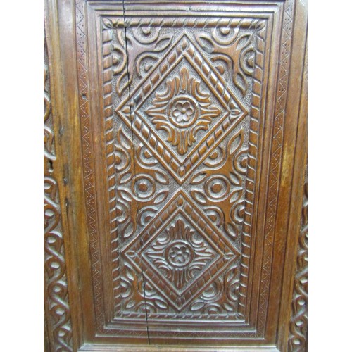 1414 - An early oak hanging corner cupboard, the carved face with geometric detail, and dated 1702, set on ... 