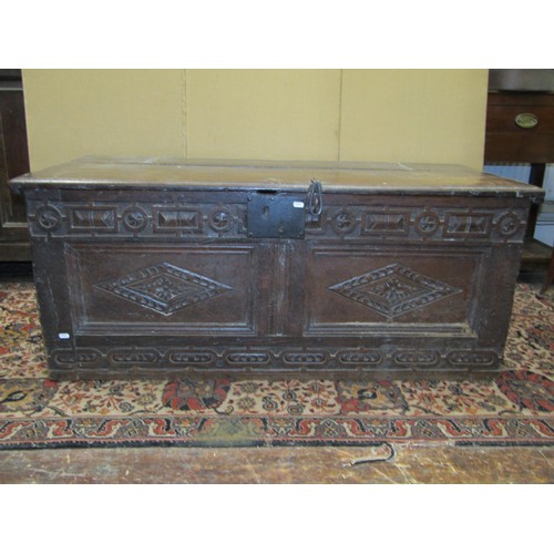 1418 - A 17th century and later oak coffer, with geometric repeating carved detail and ironwork handles, 55... 