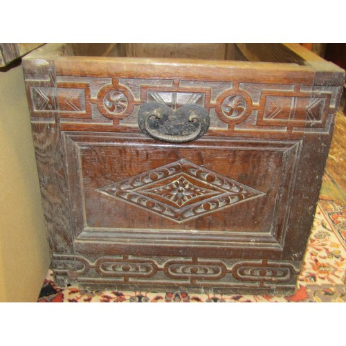 1418 - A 17th century and later oak coffer, with geometric repeating carved detail and ironwork handles, 55... 