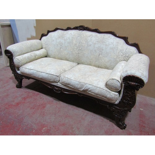 1448 - A Regency drawing room sofa with showwood frame depicting shells, scrolls and other detail, raised o... 