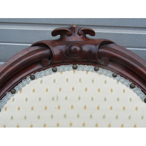 1451 - A Victorian mahogany spoon back chair with upholstered finish