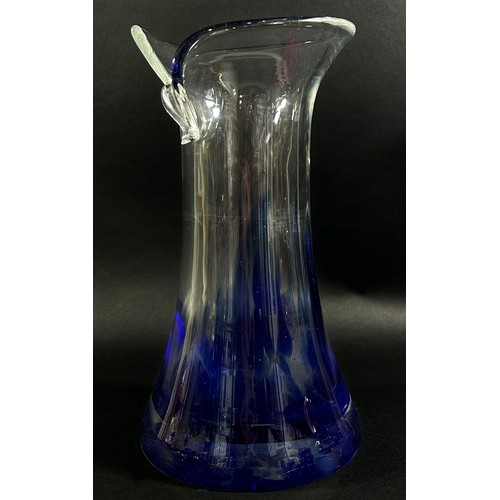 82 - A late 20th century continental glass vase with a folded torn rim, clear glass darkening to blue, 27... 