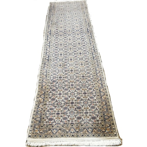 1481 - A Persian Kashan Runner with a tightly packed all over floral pattern, 315cm x 80cm approximately