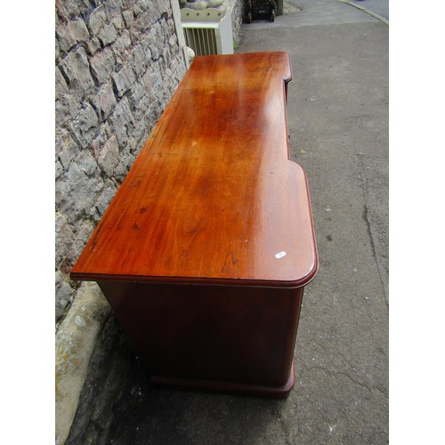 1401 - A Victorian mahogany inverted breakfront desk with two central drawers flanked by panelled cupboards... 