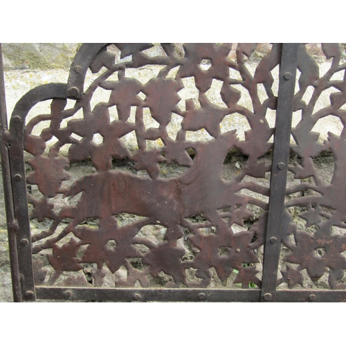 1009 - An arts and crafts style fire screen with fretted detail showing running foxes, with candle sconce e... 