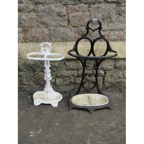 1018 - Two cast iron stick stands both with decorative finish
