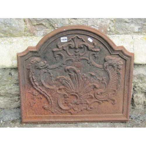 1036 - An old cast iron fire back with C scroll and other detail, 55cm high x 60cm wide