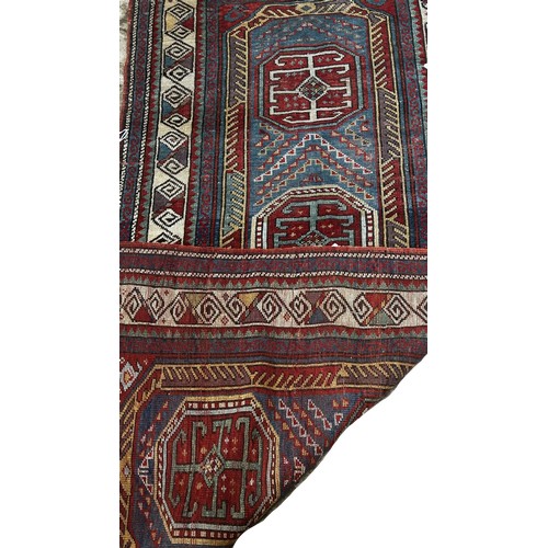 1496 - An old Kurdish Runner with a row of four tribal medallions and geometric borders, 190 x90cm approxim... 