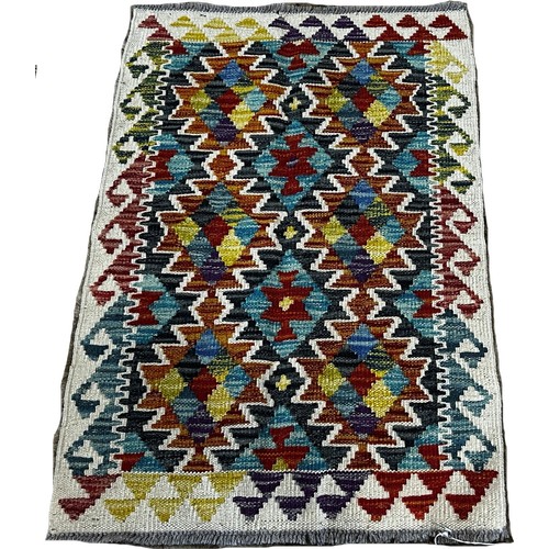 1509 - A small Chobi kilim mat with two rows of zig-zag connecting medallions, 87 x 55cm approximately