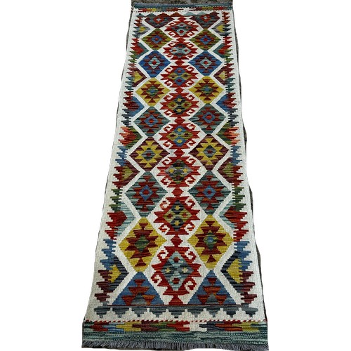 1517 - A Chobi kilim runner with alternating rows of diamonds and irregular connected medallions 196 x 62cm... 