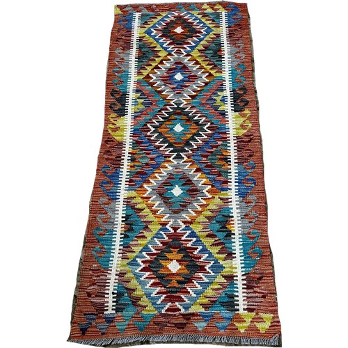 1522 - A Chobi kilim runner with five central stepped diamonds, 152 x 63cm approximately