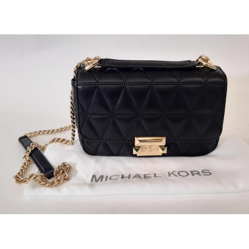 909 - 3 designer ladies hand bags comprising a small  crossbody bag by Michael Kors in quilted black leath... 