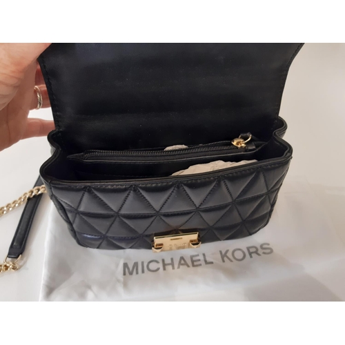 909 - 3 designer ladies hand bags comprising a small  crossbody bag by Michael Kors in quilted black leath... 