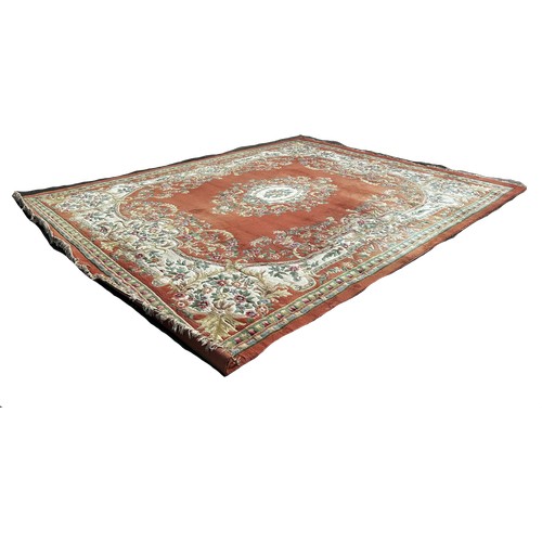 1526 - A large country house Aubusson style thick wool pile carpet with a floral medallion on an apricot fi... 