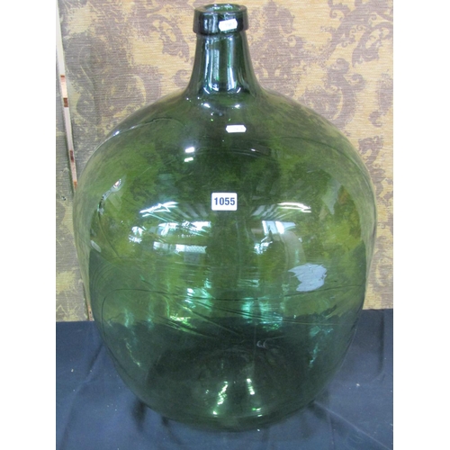 1055 - A large green hand blown glass carboy, 66cm high
