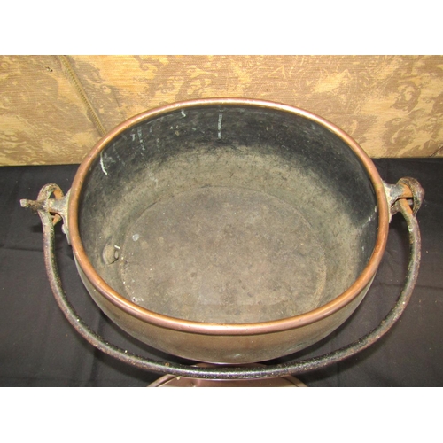 1056 - A 19th century copper boiling pot and cover with iron handle, 50cm wide
