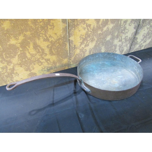 1062 - An outsized copper saucepan with iron handle, 48cm diameter