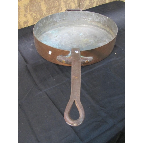 1062 - An outsized copper saucepan with iron handle, 48cm diameter