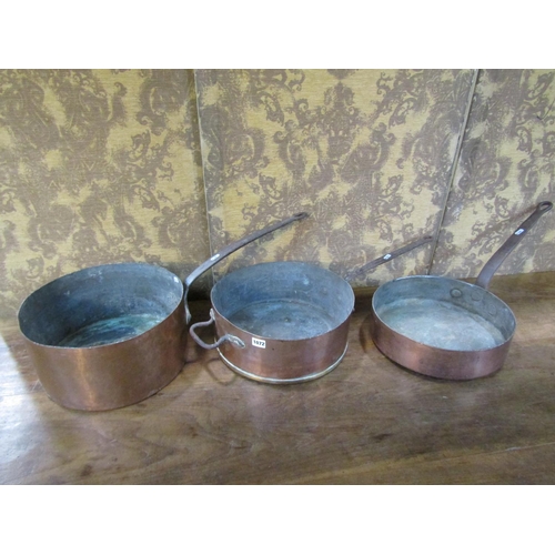 1072 - Three 19th century copper saucepans with heavy iron handles, average diameter 35cm