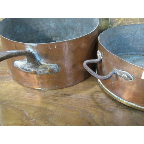 1072 - Three 19th century copper saucepans with heavy iron handles, average diameter 35cm