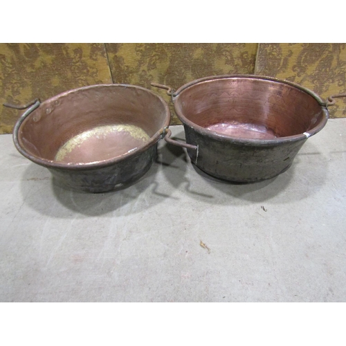 1078 - Two large 19th century copper pans with central iron handles, 60cm diameter