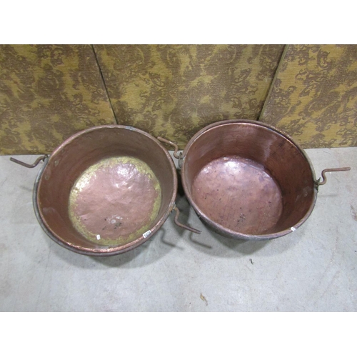 1078 - Two large 19th century copper pans with central iron handles, 60cm diameter