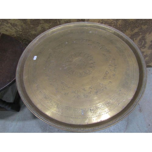 1083 - An old English oak drop leaf occasional table together with an Indian brass tray top table with fold... 