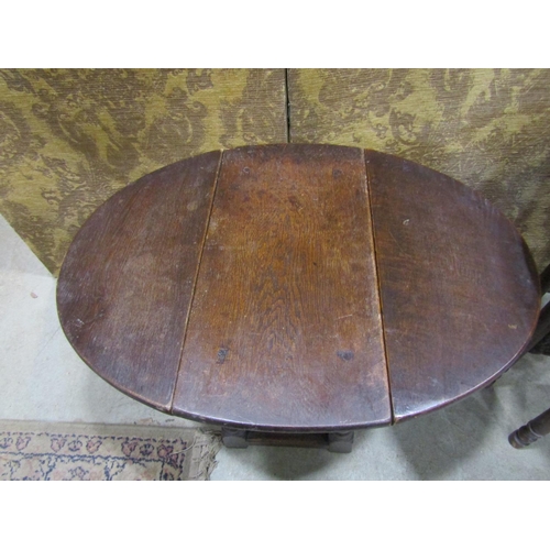 1083 - An old English oak drop leaf occasional table together with an Indian brass tray top table with fold... 