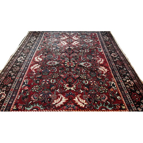 1503 - A Persian Hamadan type carpet with an all over floral pattern on a predominantly red ground, 290 x 2... 