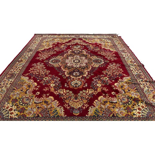 1519 - A large machine made Persian type carpet with a broad central floral medallion and scrolling flowers... 