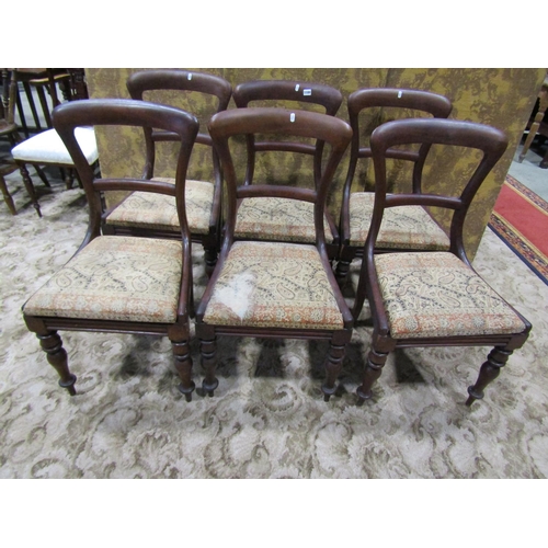 1100 - A set of six Victorian mahogany dining chairs on turned legs