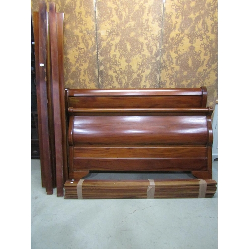 1258 - A mahogany sleigh bed frame of usual form to accept a 5ft mattress