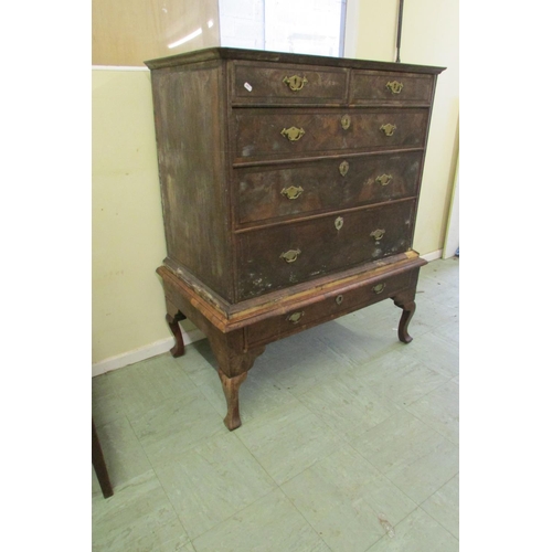 1437 - A Georgian walnut chest on stand of three long and two short graduated drawers, the stand enclosing ... 