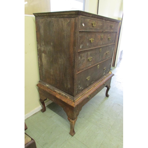 1437 - A Georgian walnut chest on stand of three long and two short graduated drawers, the stand enclosing ... 