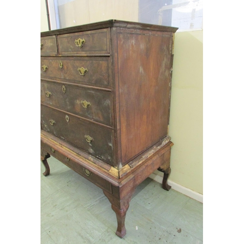 1437 - A Georgian walnut chest on stand of three long and two short graduated drawers, the stand enclosing ... 