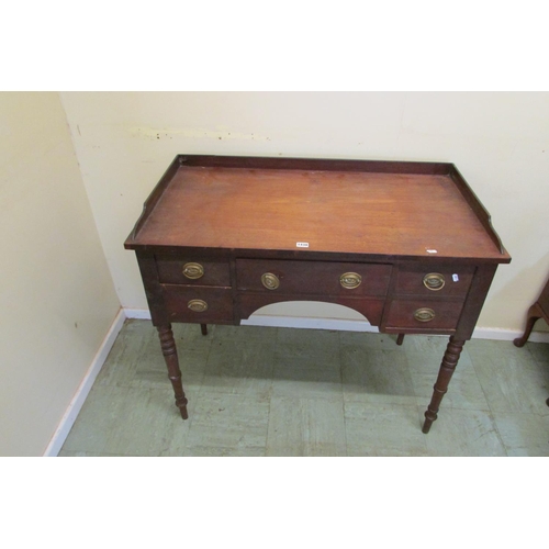 1438 - A mid Victorian mahogany kneehole dressing table fitted with an arrangement of four drawers raised o... 