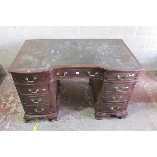 1440 - An Edwardian mahogany pedestal writing desk with inset leather top, the shaped outline incorporating... 