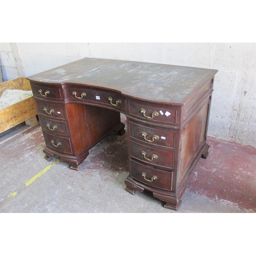 1440 - An Edwardian mahogany pedestal writing desk with inset leather top, the shaped outline incorporating... 