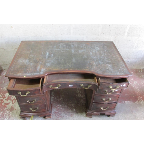 1440 - An Edwardian mahogany pedestal writing desk with inset leather top, the shaped outline incorporating... 