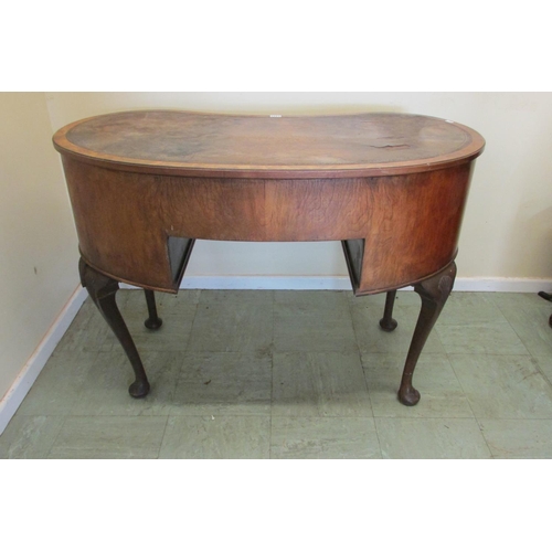 1441 - A walnut framed kneehole kidney shaped writing desk fitted with five drawers on pad feet with shell ... 