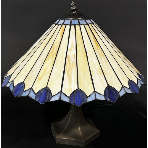 112 - A Tiffany style lamp with a conical shaped “lead” segmented glass shade and two pyramid Tiffany styl... 